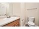 Neutral bathroom with a single sink vanity, standard toilet, and framed mirror at 3599 Brookstone Way, Union City, GA 30291