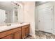 Bathroom featuring a double sink vanity, framed mirror, and neutral flooring at 3599 Brookstone Way, Union City, GA 30291