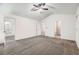 Large carpeted bedroom featuring ceiling fan and multiple entry points at 3599 Brookstone Way, Union City, GA 30291