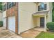Close-up of the home featuring a two-car garage and covered front porch at 3599 Brookstone Way, Union City, GA 30291
