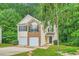 Well-maintained two-story home featuring a two-car garage and lush greenery at 3599 Brookstone Way, Union City, GA 30291