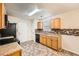 Well-equipped kitchen features wooden cabinets, stainless steel appliances, and tiled flooring at 3599 Brookstone Way, Union City, GA 30291