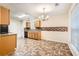 Bright eat-in kitchen featuring wood cabinets, mosaic backsplash, and neutral tile floor at 3599 Brookstone Way, Union City, GA 30291