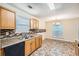 Charming eat-in kitchen featuring wood cabinets, mosaic backsplash, and stainless steel sink at 3599 Brookstone Way, Union City, GA 30291