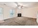 Cozy living room with a fireplace, neutral carpet, and large window at 3599 Brookstone Way, Union City, GA 30291