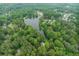 Overhead shot displaying a lake community surrounded by lush green trees at 5219 Legendary Ln, Acworth, GA 30102