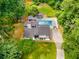 Aerial view of the home with a sparkling pool, lush greenery, and a private outdoor area, creating a serene oasis at 5219 Legendary Ln, Acworth, GA 30102