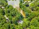 Aerial view featuring a community with a lake and houses nestled amongst the trees at 5219 Legendary Ln, Acworth, GA 30102