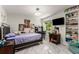 Bright bedroom with a built in bookshelf, marble floors, and a large window at 5219 Legendary Ln, Acworth, GA 30102