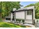 Side view of a modern home with manicured landscaping, a striking facade, and a well-lit pathway at 5219 Legendary Ln, Acworth, GA 30102