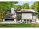 Contemporary home featuring a modern exterior, unique architectural details, and a well-maintained yard at 5219 Legendary Ln, Acworth, GA 30102