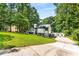 Contemporary two-story home with a manicured lawn and a long driveway at 5219 Legendary Ln, Acworth, GA 30102