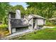 Modern home showcasing its sleek lines and unique design nestled amongst mature trees at 5219 Legendary Ln, Acworth, GA 30102