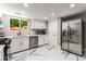 Bright kitchen with stainless steel appliances, white cabinets, a window view, and marble floors at 5219 Legendary Ln, Acworth, GA 30102
