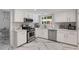 Modern kitchen with white cabinets, stainless steel appliances, and marble countertops, perfect for cooking at 5219 Legendary Ln, Acworth, GA 30102