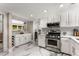 Well-lit kitchen featuring white cabinets, stainless steel appliances, and marble countertops, ideal for culinary enthusiasts at 5219 Legendary Ln, Acworth, GA 30102