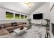 Cozy living room featuring a comfortable sectional, large windows, and stylish decor, great for relaxing at 5219 Legendary Ln, Acworth, GA 30102