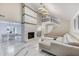 Bright living room boasting a modern fireplace, open layout to the dining area, and upscale marble flooring at 5219 Legendary Ln, Acworth, GA 30102