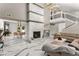 Open-concept living room featuring a grand fireplace, staircase, and elegant marble floors, perfect for entertaining at 5219 Legendary Ln, Acworth, GA 30102
