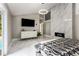 Spacious main bedroom with a fireplace, mounted TV, and sleek marble floors at 5219 Legendary Ln, Acworth, GA 30102