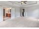 Bedroom with neutral carpet and views to the bathroom and another room through open doorways at 1374 Highland Wood Ct, Auburn, GA 30011