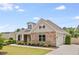 Attractive single-story home featuring stone accents, a side-entry garage, and a well-maintained lawn at 1374 Highland Wood Ct, Auburn, GA 30011