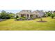 Inviting single-story home with a stone facade, lush green lawn, and tasteful landscaping at 1374 Highland Wood Ct, Auburn, GA 30011