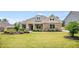 Beautiful single-story home with a stone facade, manicured lawn, and professionally landscaped front yard at 1374 Highland Wood Ct, Auburn, GA 30011
