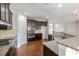 Stylish kitchen with granite counters, stainless appliances, dark wood cabinets, and gas range at 1374 Highland Wood Ct, Auburn, GA 30011