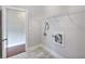 Bright laundry room featuring tile flooring, wire shelf, and washer/dryer hookups at 1374 Highland Wood Ct, Auburn, GA 30011