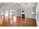Open living room with fireplace, hardwood floors, and abundant natural light at 1374 Highland Wood Ct, Auburn, GA 30011