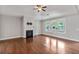 Cozy living room features a fireplace, hardwood floors, and large windows at 1374 Highland Wood Ct, Auburn, GA 30011