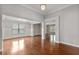 Spacious living room with hardwood floors, recessed lighting, and decorative molding at 1374 Highland Wood Ct, Auburn, GA 30011