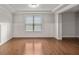 Inviting living space with hardwood floors, large window, and decorative paneling at 1374 Highland Wood Ct, Auburn, GA 30011