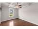 Open and bright living space with hardwood floors, coffered ceiling, and a large window at 1374 Highland Wood Ct, Auburn, GA 30011