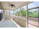Bright screened porch with ceiling fan and access to the deck at 1374 Highland Wood Ct, Auburn, GA 30011