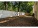 Fenced backyard featuring green foliage and privacy for outdoor enjoyment at 208 Oconee Way, Canton, GA 30114
