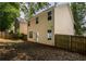 View of the home's backyard featuring a wooden fence, lawn, and exterior wall at 208 Oconee Way, Canton, GA 30114