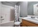 Bathroom featuring a shower-tub combination with modern fixtures and a neutral-toned vanity at 208 Oconee Way, Canton, GA 30114