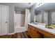 Full bathroom with wood look floors, vanity, shower and tub combo at 208 Oconee Way, Canton, GA 30114