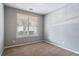 Cozy bedroom with neutral walls, carpeted flooring, and a window providing natural light at 208 Oconee Way, Canton, GA 30114