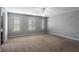 Spacious bedroom with neutral carpet, fan and three windows at 208 Oconee Way, Canton, GA 30114