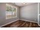 Bright bedroom with hardwood floors, large window, and modern light fixture at 208 Oconee Way, Canton, GA 30114