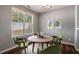 Dining room with round table, four chairs, light gray walls and decorative artwork at 208 Oconee Way, Canton, GA 30114