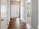 Bright foyer with wood-look floors, a nearby doorway and natural light streaming through the front door at 208 Oconee Way, Canton, GA 30114