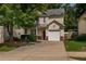 Charming two-story home with an attached garage, well-maintained lawn, and inviting curb appeal at 208 Oconee Way, Canton, GA 30114
