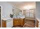 Bright kitchen featuring wood cabinets, stainless steel sink, and an open view to dining area at 208 Oconee Way, Canton, GA 30114