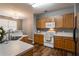 Well-lit kitchen featuring wood cabinets, modern appliances, and a stainless steel sink at 208 Oconee Way, Canton, GA 30114
