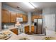 Well-lit kitchen with wood cabinets, modern appliances, and ample counter space at 208 Oconee Way, Canton, GA 30114