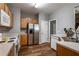 Modern kitchen with stainless steel appliances and wood cabinets, offering a clean and functional space at 208 Oconee Way, Canton, GA 30114